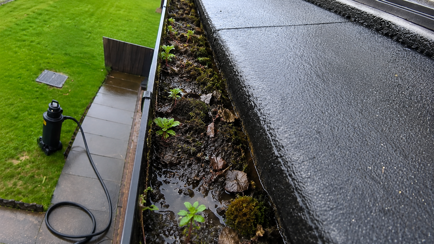 Birmingham gutter before summer health check showing accumulated debris, silt and moss buildup